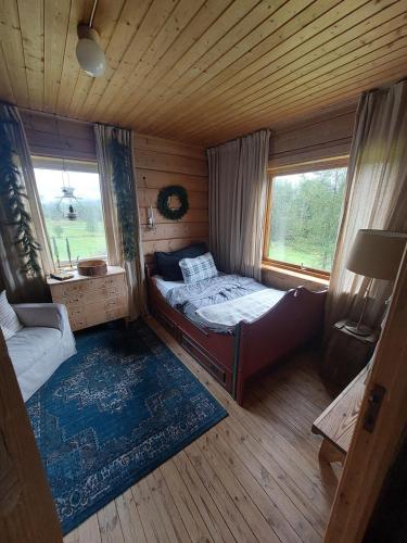a small bedroom with a bed and a window at Llama Lodge Authentic Sunnfjord Farm in Kleivane