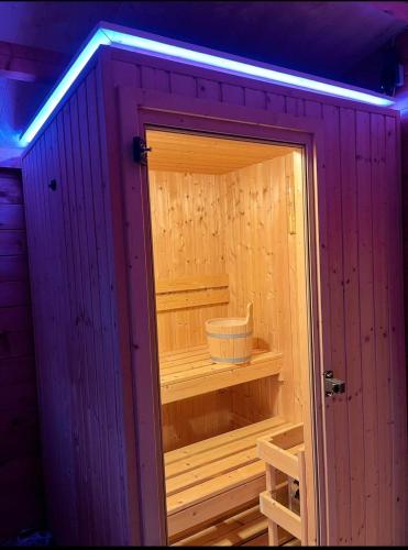 a wooden sauna with a light on the inside at Ferienhaus Cris und Alex in Stühlingen