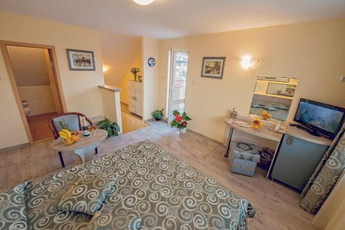 a bedroom with a bed and a desk and a television at Supreme Victoria in Varna City