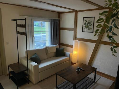 a living room with a couch and a table at Studio with Kitchen & Parking near Thun and Bern in Herbligen 