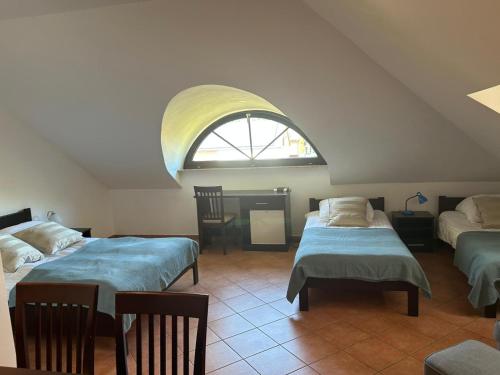a room with two beds and a table and a window at Dom Gościnny Klemens in Dębki