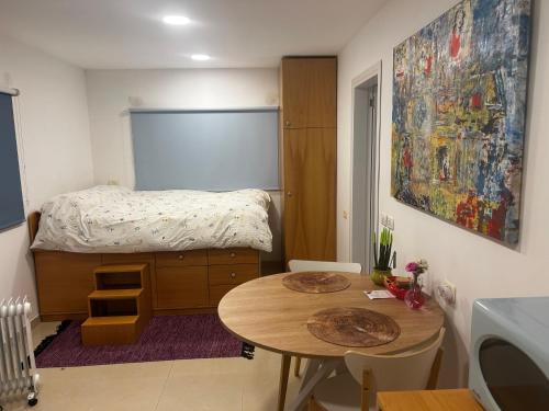 a small bedroom with a table and a bed at Iris privet room in Mevasseret Zion
