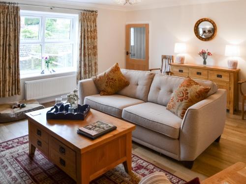 a living room with a couch and a coffee table at Number 23 in Wooler