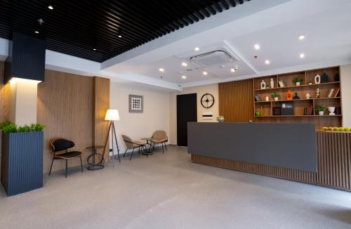an office lobby with a reception desk and chairs at Hotel Tiflida in Tbilisi City