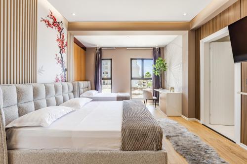 a bedroom with a large bed and a television at Villa Verona in Durrës