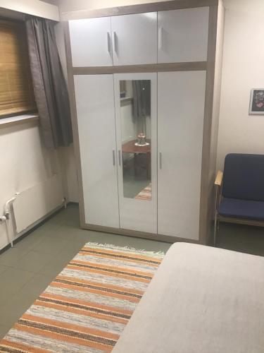 a room with a white cabinet and a rug at Hyryntie 33 as 3 in Hyrynsalmi