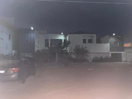 a parking lot in front of a house at night at ESSERa in Nouakchott