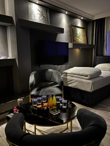 a bedroom with a bed and a table and a chair at Hevsel hotel in Diyarbakır