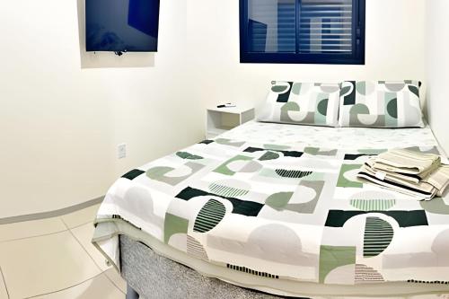 a bedroom with a bed with a comforter and pillows at Vacanze - Alicante in Maceió