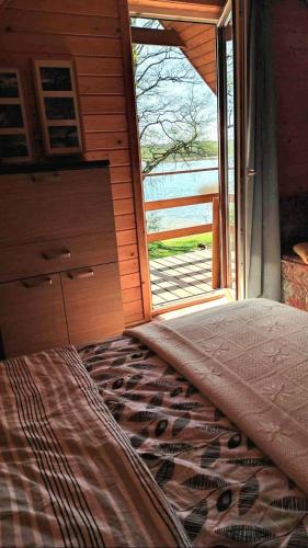 a bedroom with a bed in front of a window at Rodzinny Domek Ruś in Ruś