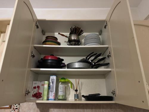 a kitchen cabinet filled with dishes and utensils at Civitavecchia Port in Civitavecchia