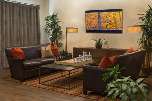 a living room with two couches and a chess board on a table at Arabella Hotel Sedona in Sedona