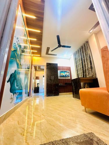 a living room with a couch and a ceiling fan at 1BHK Stay in Sibsāgar