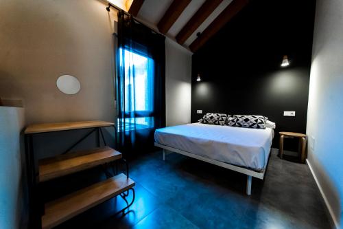 a bedroom with a bed and a large window at El Mirador Del Alcazar in Segovia