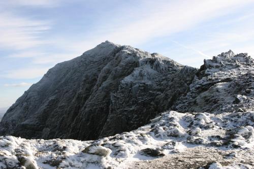a mountain covered in snow and ice at Penmachno Hall - self catering suite in Betws-y-coed