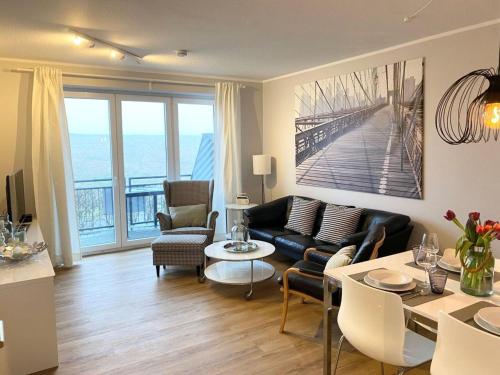 a living room with a couch and a table at Ferienwohnung, St Peter - Ording in Böhl