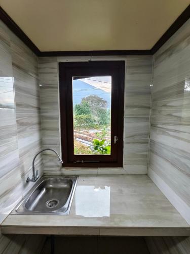 a kitchen with a sink and a window at Sembalun agro villa&restoran in Sembalun Lawang