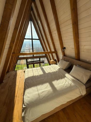 a bed in a room with a large window at KosMy dream in Sopot