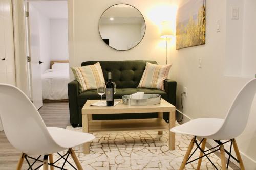 a living room with a green couch and a table at 2BDR Stylish Comfort Parkside in Vancouver