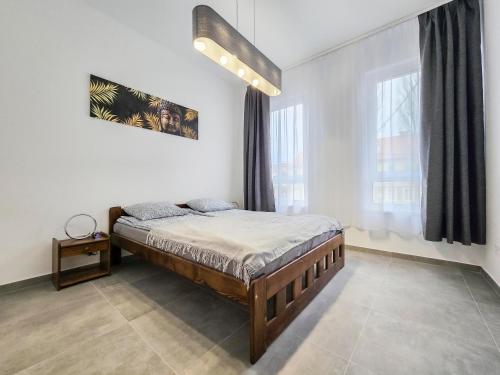 a bedroom with a bed and a large window at PP Home in Törökbálint