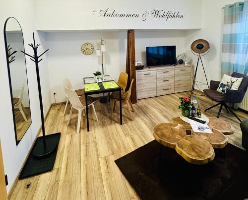 a living room with a table and a dining room at Harz Flair Schierke in Schierke