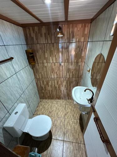 a bathroom with a toilet and a sink at Sereia beach chalé in Icapuí