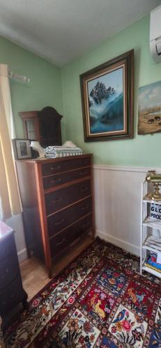 a room with a dresser and a rug at Trout House by Trout Lake in Vancouver