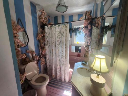 a bathroom with a toilet and a window at Trout House by Trout Lake in Vancouver