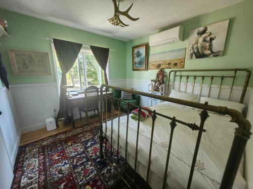 a bedroom with a bed and a dining room at Trout House by Trout Lake in Vancouver