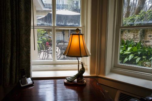 a lamp sitting on a table in front of a window at Eliza Thompson House, Historic Inns of Savannah Collection in Savannah