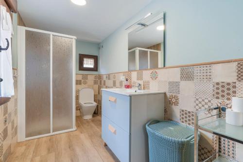 a bathroom with a sink and a toilet at Casa Rural Casa Clemen in Villalba Baja