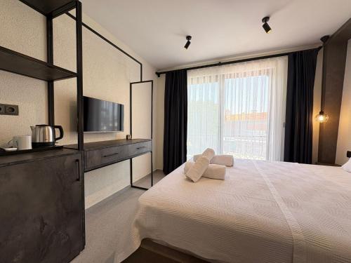 a bedroom with a large bed and a large window at Arıcan Pansiyon in Fethiye