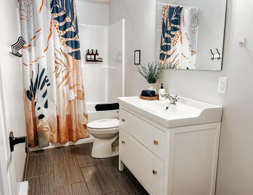 a white bathroom with a toilet and a sink at Sooke BnB Otter Point Getaway - Relax & Recharge in Nature, Private 7min to Sooke in Sooke