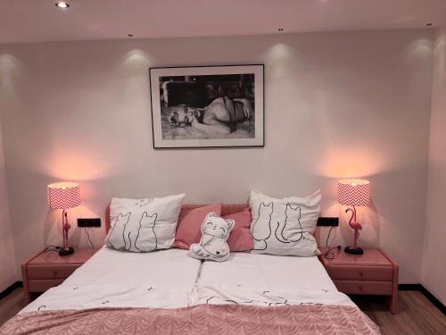 a bedroom with a bed with a teddy bear on it at unique Ferienwohnung in Leutkirch im Allgäu
