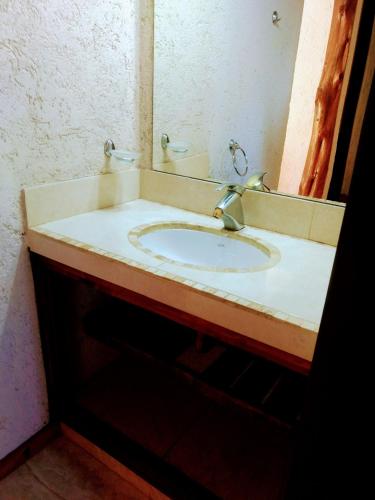 a bathroom with a sink and a mirror at Tierra Nuestra in Villa Ciudad de América