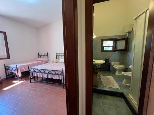 a bedroom with a bed and a bathroom with a sink at Il Lentischio Casa 3 in Nulvi