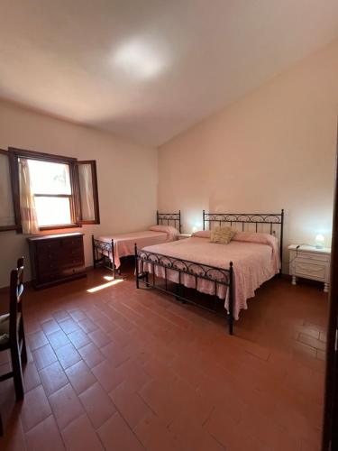 a bedroom with a bed and a window at Il Lentischio Casa 3 in Nulvi