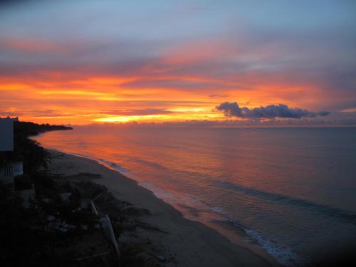a sunset over a beach with the ocean at Casa Caracol in Playa Coronado