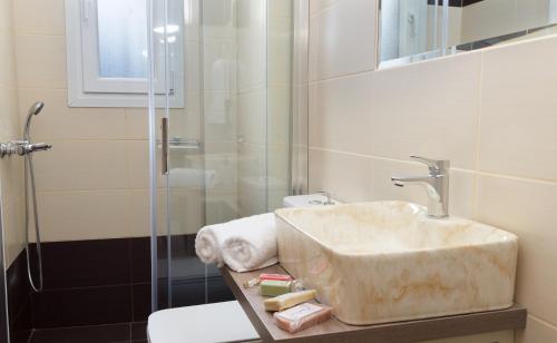 a bathroom with a sink and a shower at Alexandra's Residence in Kefallonia