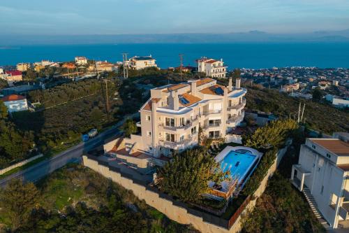 an aerial view of a house with a swimming pool at Villa Bijoux SeaView Pool near Athens airport in Neos Voutzas