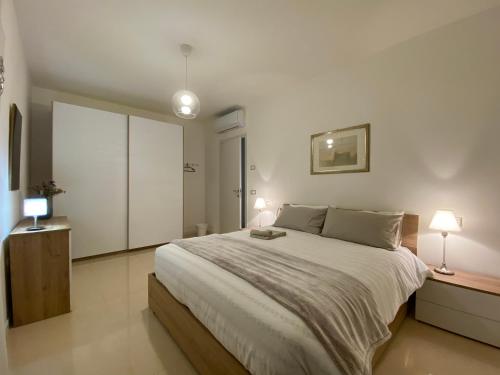 a bedroom with a large bed and two lamps at Respiro di Bosco in Robbiate
