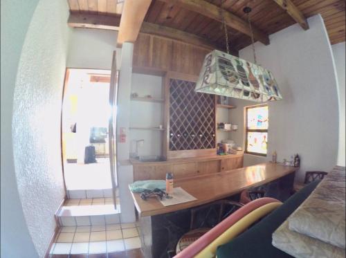 a kitchen with a wooden counter and a table at Casa Grande Lomas de Cocoyoc in Texcalpan