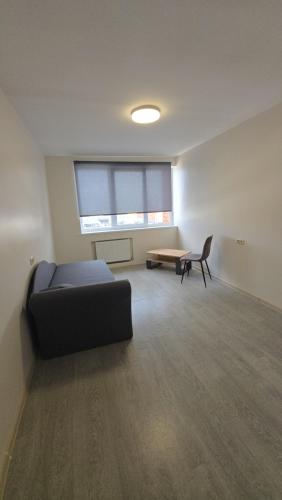 a living room with a couch and a table at Hostel istaba in Rēzekne