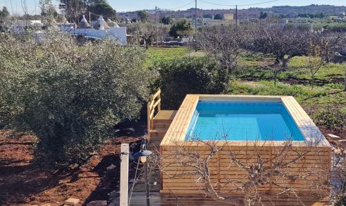 a swimming pool on a set of stairs with trees at Trulli Beauty Romantic ALCOVA con piscina in Locorotondo