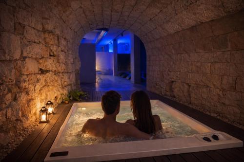 a man and a woman sitting in a bath tub at Villa Rosa Resort in Conversano