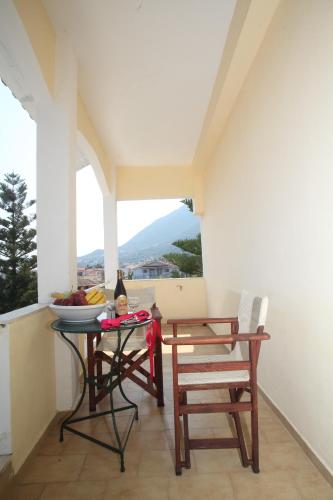a table and chairs on a balcony with a view at Hotel Pegasos in Nikiana