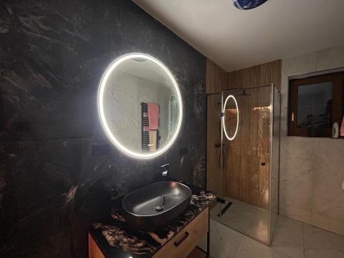 a bathroom with a sink and a mirror on the wall at BABA JAGA na szlaku in Nowa Słupia