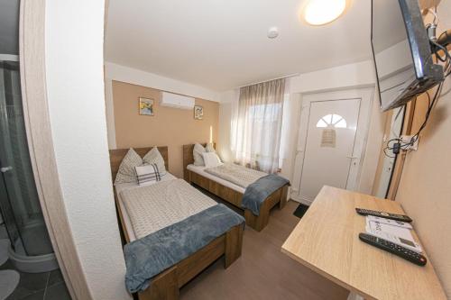 a small room with two beds and a table at Matrakapuvendeghaz in Mátraszőlős