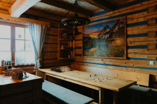 a room with a wooden wall with a chess board at Granddrevenica in Malá Franková