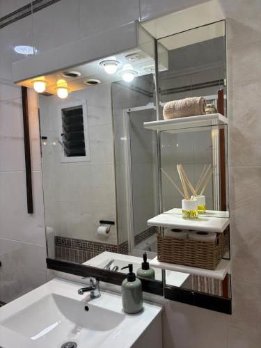 a bathroom with a sink and a mirror at The Ruzafa by Laura - AVE in Valencia